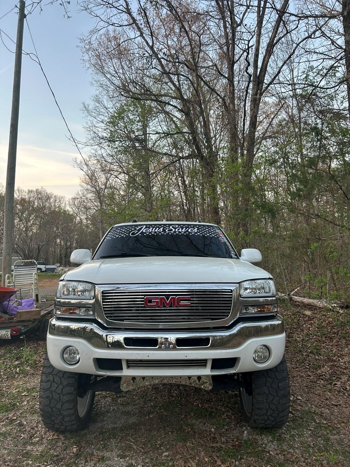 Jesus Saves windshield banner on a lifted white GMC