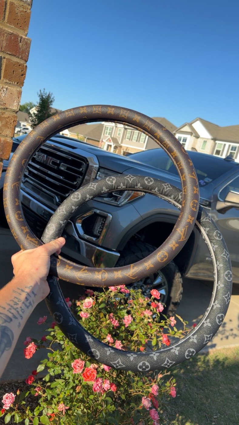 Louis Vuitton pattern custom steering wheel covers in front of a GMC truck